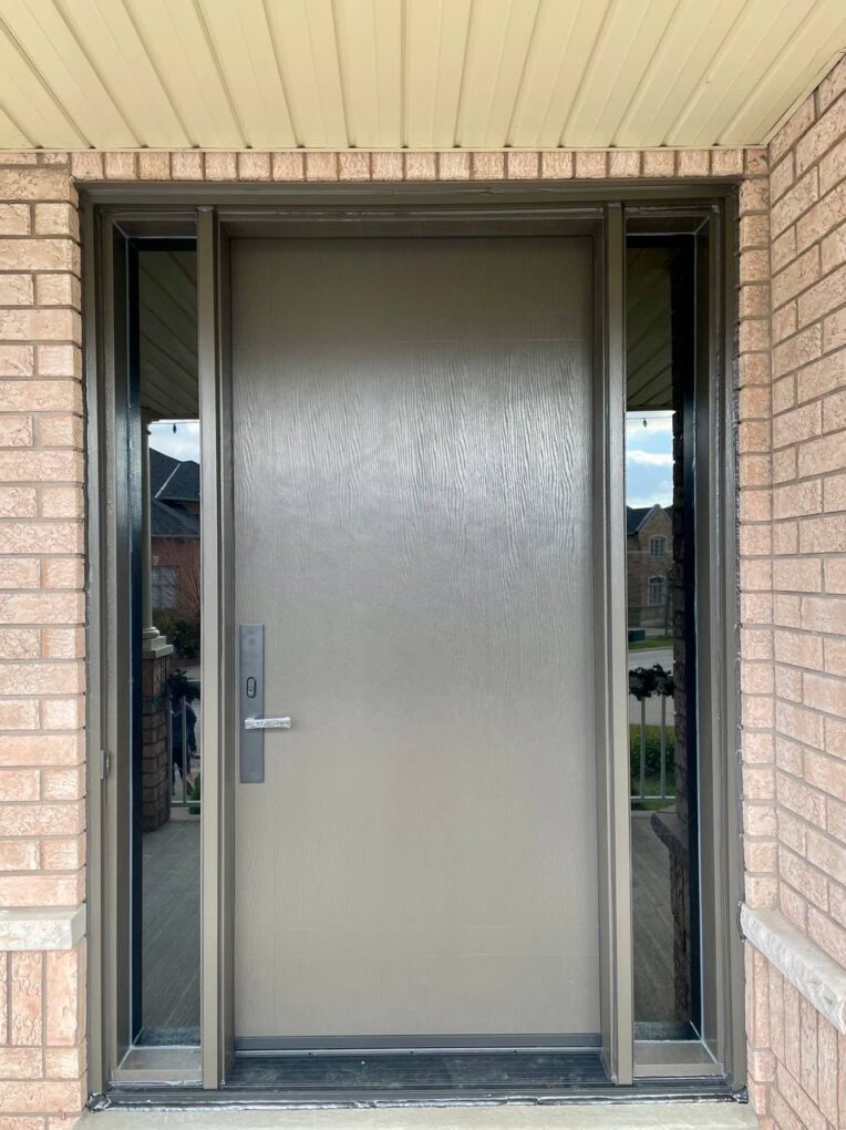 After – modern fiberglass entry door with dual slim glass sidelites on a Woodbridge brick façade.