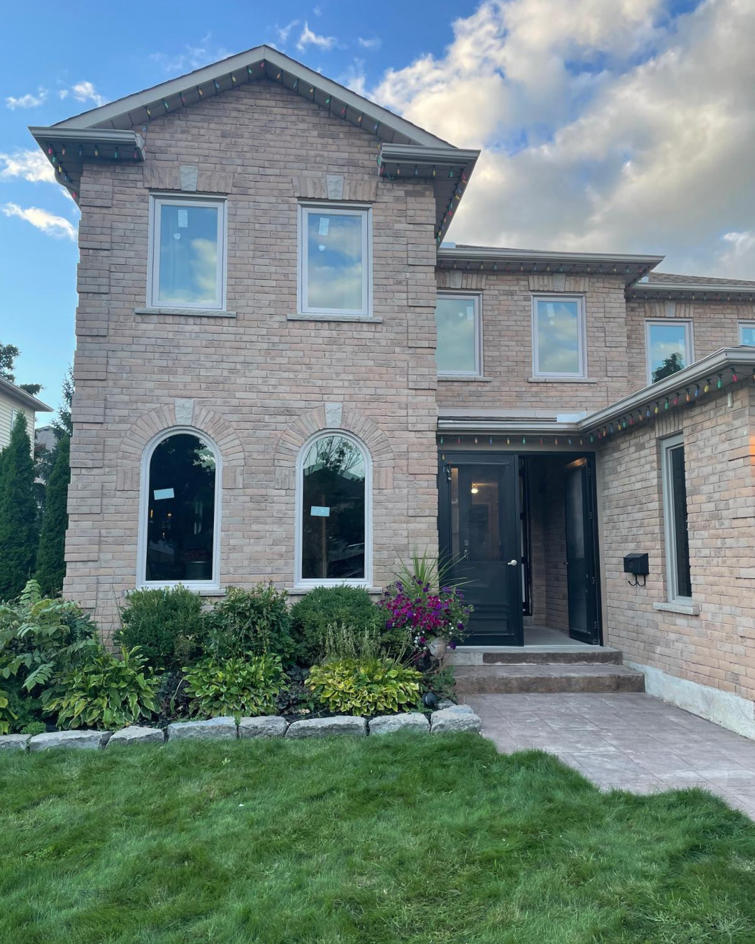 Brick home with two main-floor custom arched windows