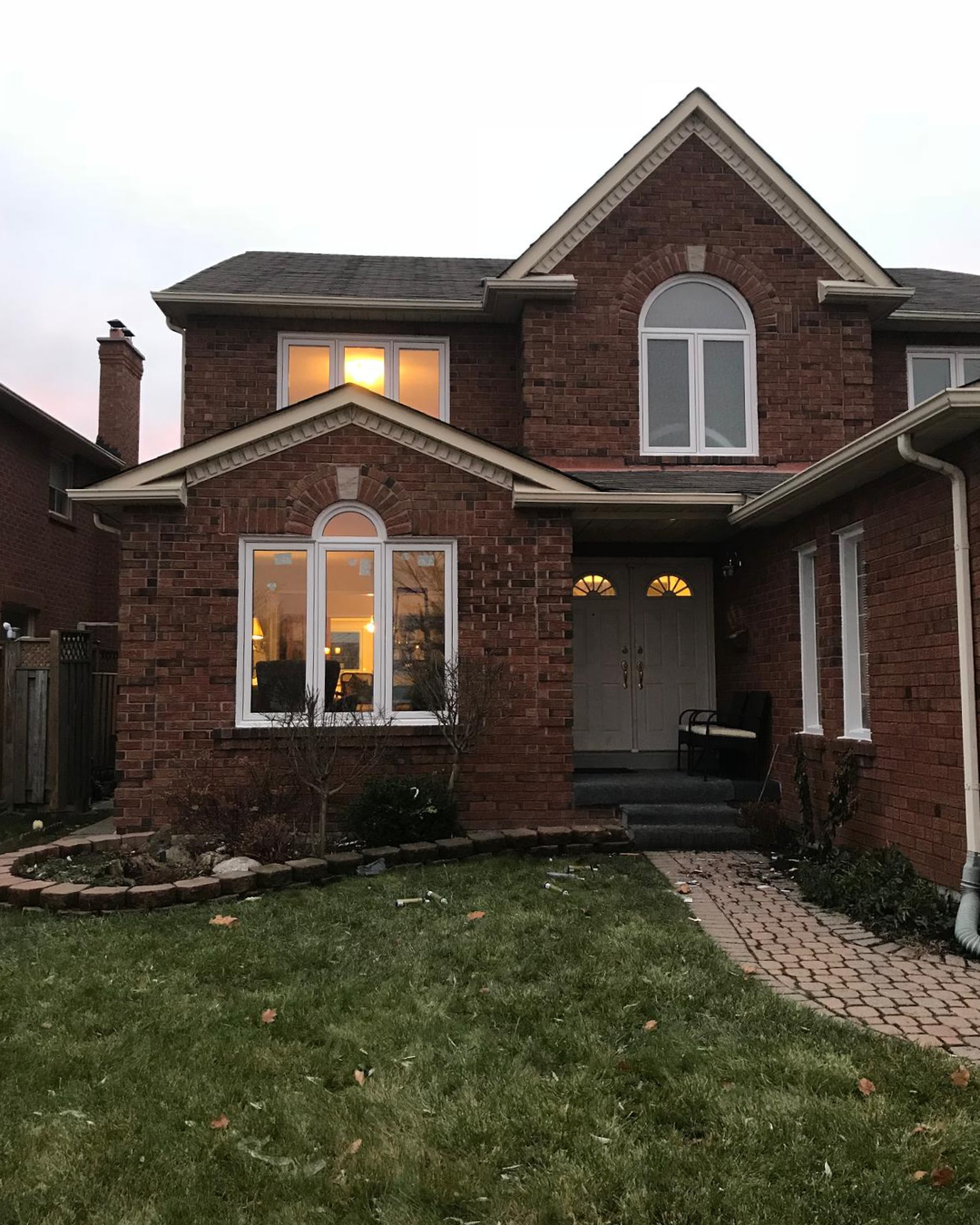 Brick house front elevation with white arched windows