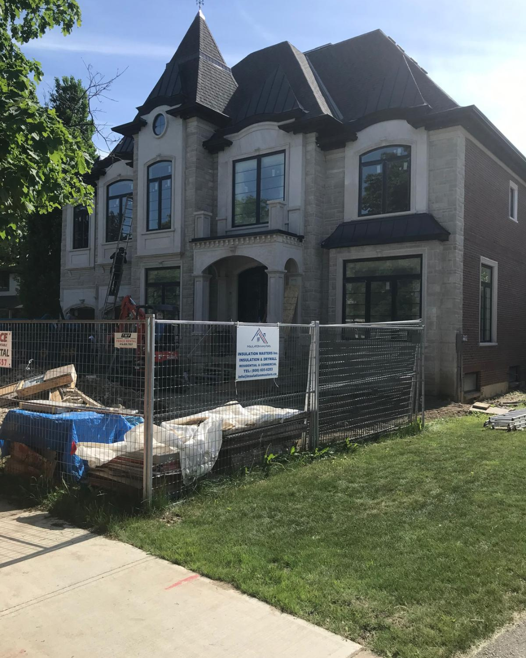 Front view of custom home with matching arched windows