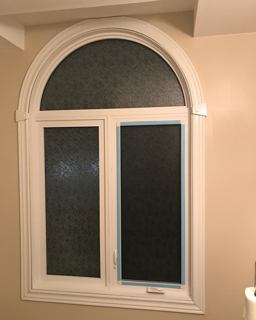 Interior arched windows with white frame and obscure glass