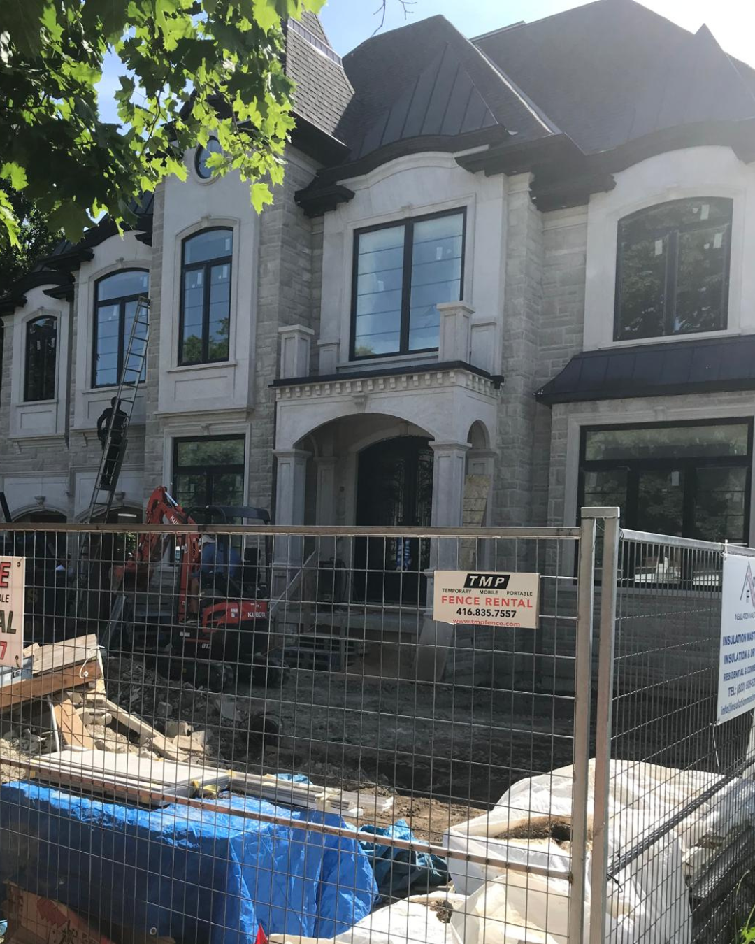 Large stone house with multiple black arched windows