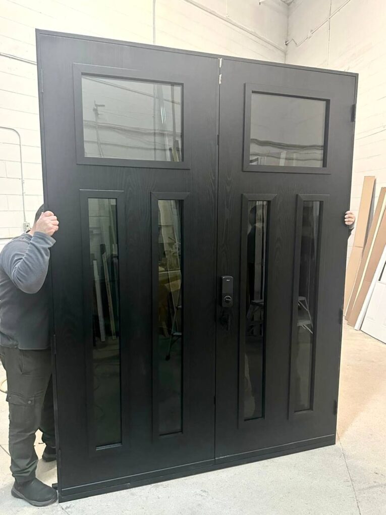 8 ft fiberglass double entry doors with dark woodgrain finish shown in the shop before delivery.