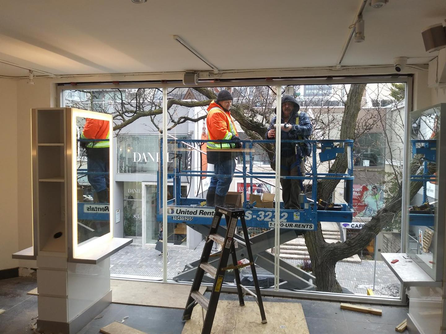 Large frameless tempered glass window with door for a Yorkville retail storefront