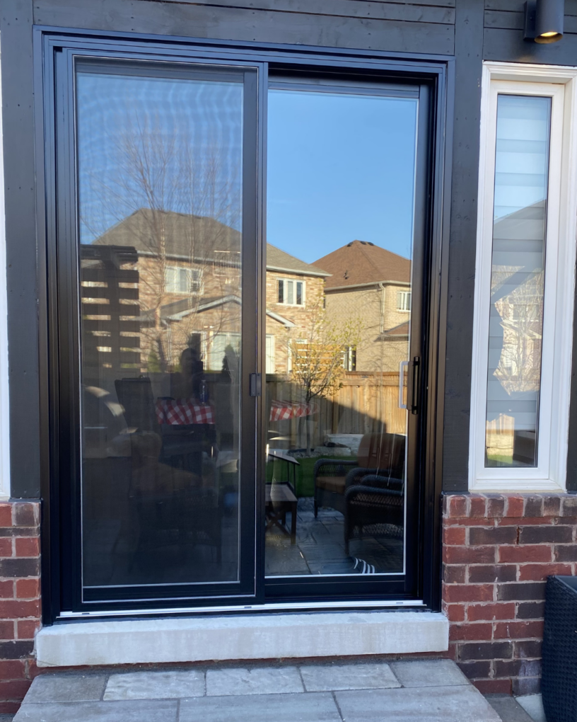 Modern black-framed 2 panel sliding doors in a Toronto home with a clearer backyard view