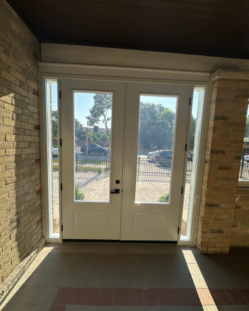 Wide view of the heritage façade with updated windows and entry door in Toronto