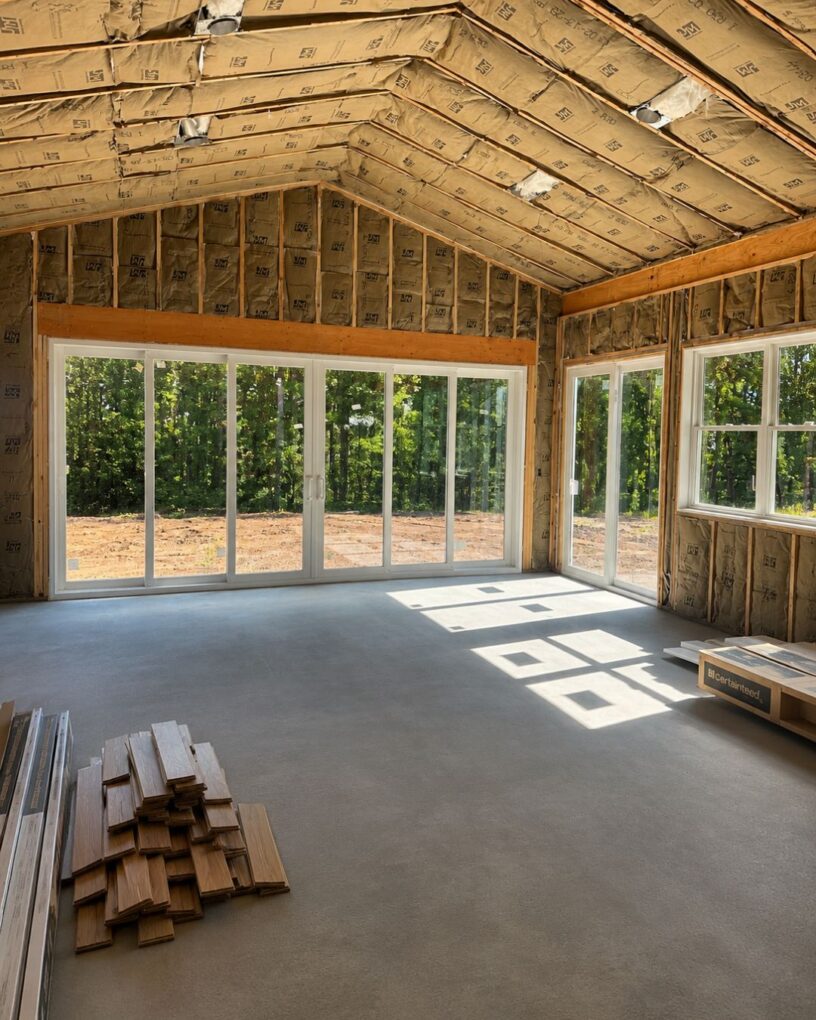 Interior-view-of-a-large-unfinished-room-with-a-6-panel-sliding-patio-door-bringing-in-more-daylight