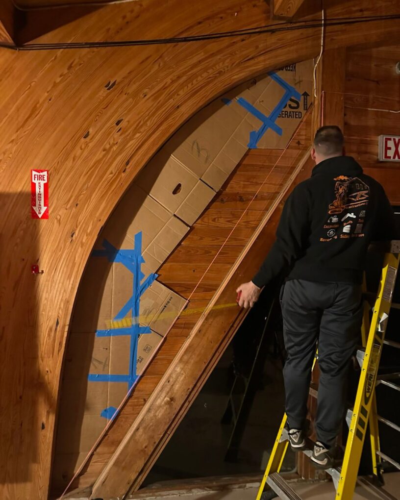 Workers installing custom window and sliding door sections inside the Moonrise Valley project.