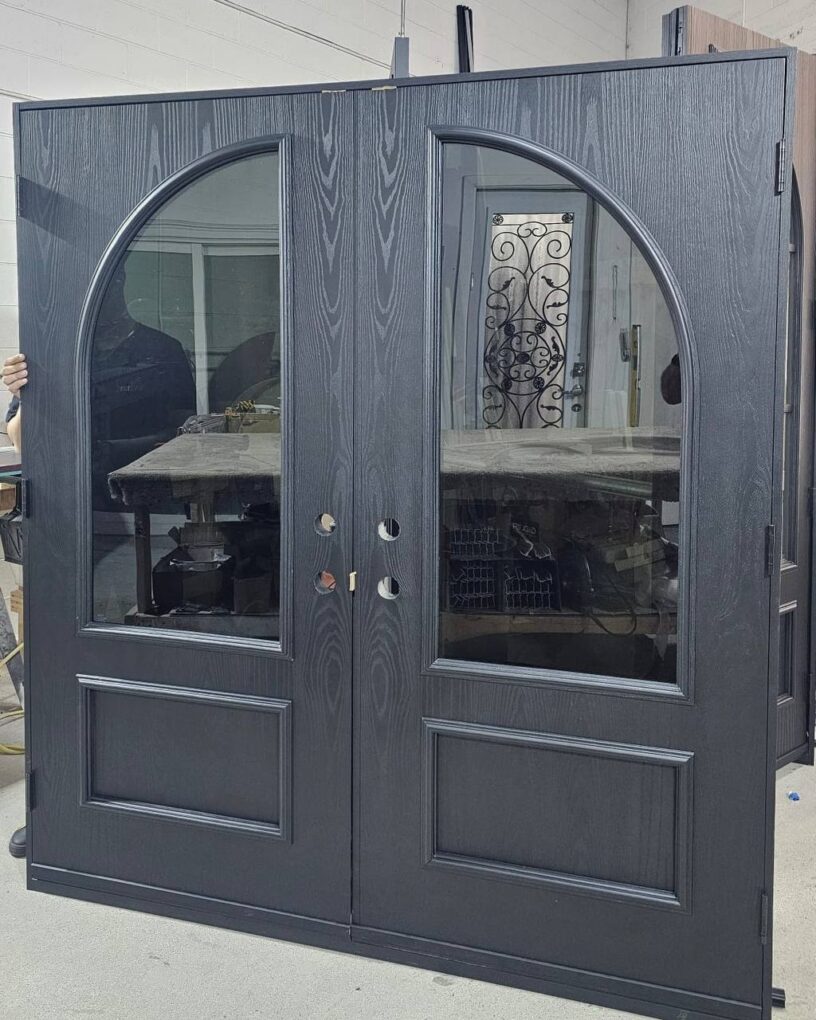 Woodgrain fiberglass double doors with matching curved glass inserts